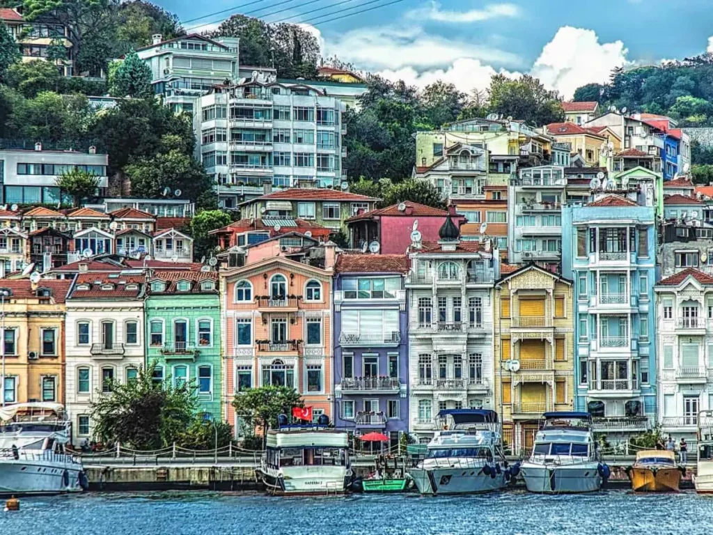 Colorful buildings and boats along the Bosphorus in Istanbul, Turkey, showcasing vibrant architecture and waterfront charm.