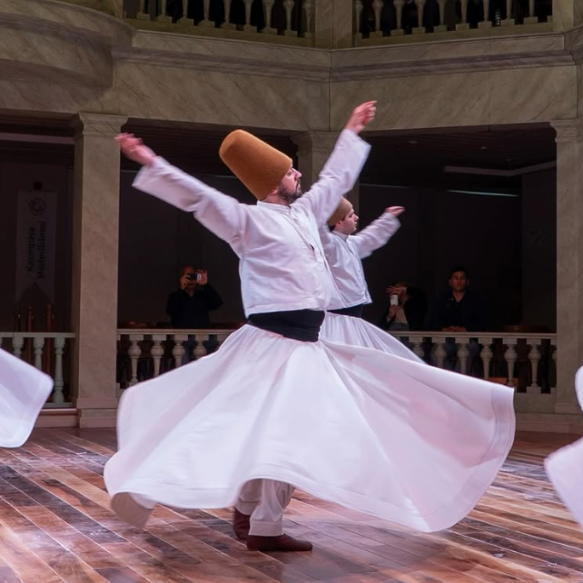 Whirling Dervishes perform traditional Sufi dance, showcasing spirituality and cultural heritage in an elegant setting.