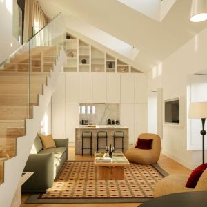 Bright open-plan living area with wooden staircase, modern kitchen, and lounge space with patterned rug.