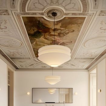 Ornate ceiling with classical fresco and modern pendant lights in elegant room.