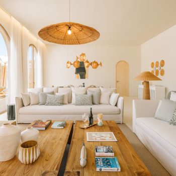 Ando Living Comporta Villas. Bright and airy living room with stylish decor, featuring cozy sofas, wooden coffee table, and unique lighting.