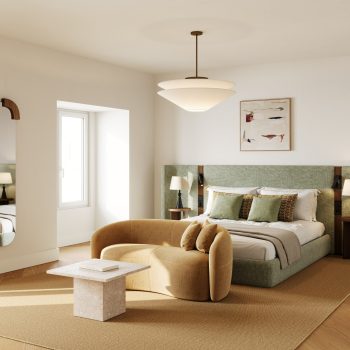 Modern bedroom with stylish furniture, green bed, cozy couch, abstract art, and natural lighting from a window.