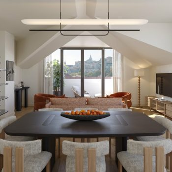 Modern living room with dining area, large window view, stylish furniture, and neutral decor.