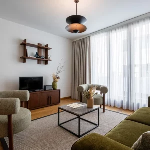 Modern living room with stylish furniture, natural light, and decorative plants, creating a cozy atmosphere.